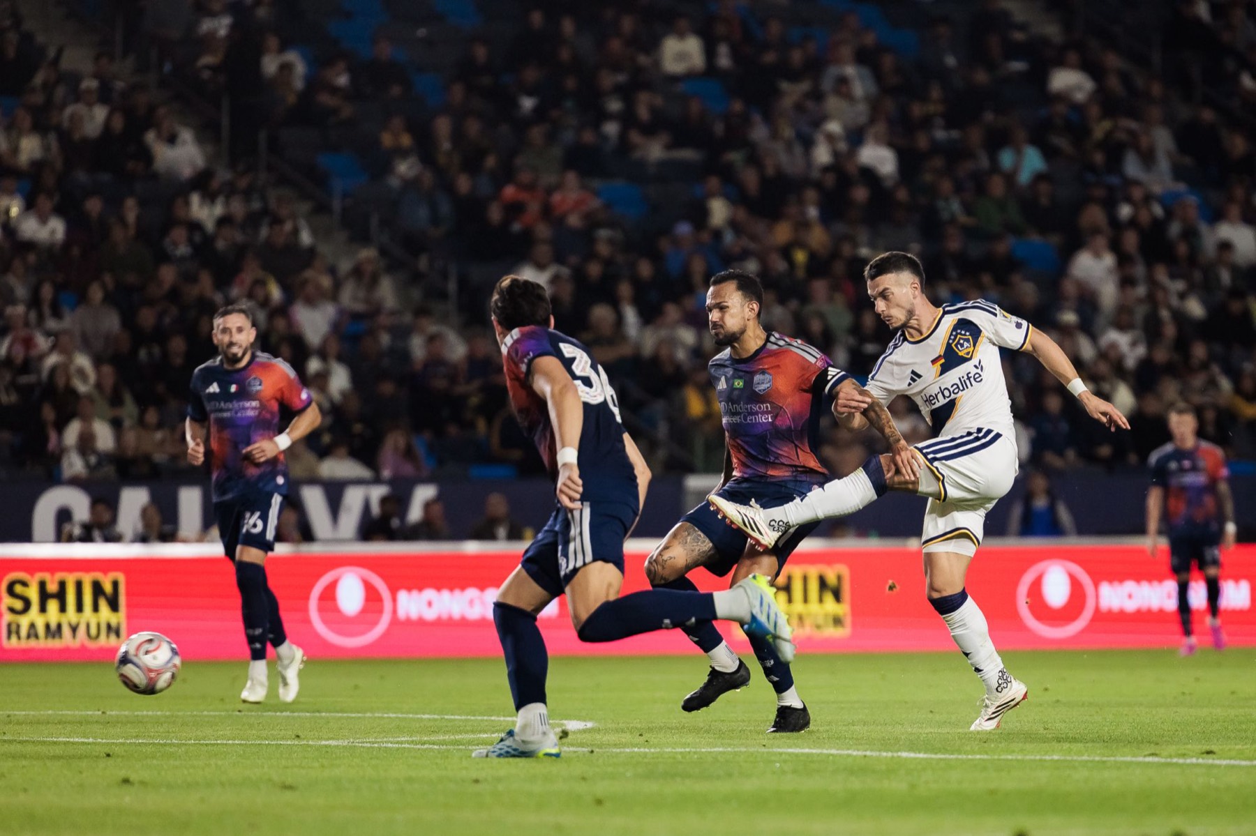 LA Galaxy player shooting in front of Shin Ramyun and Nongshim LED boards