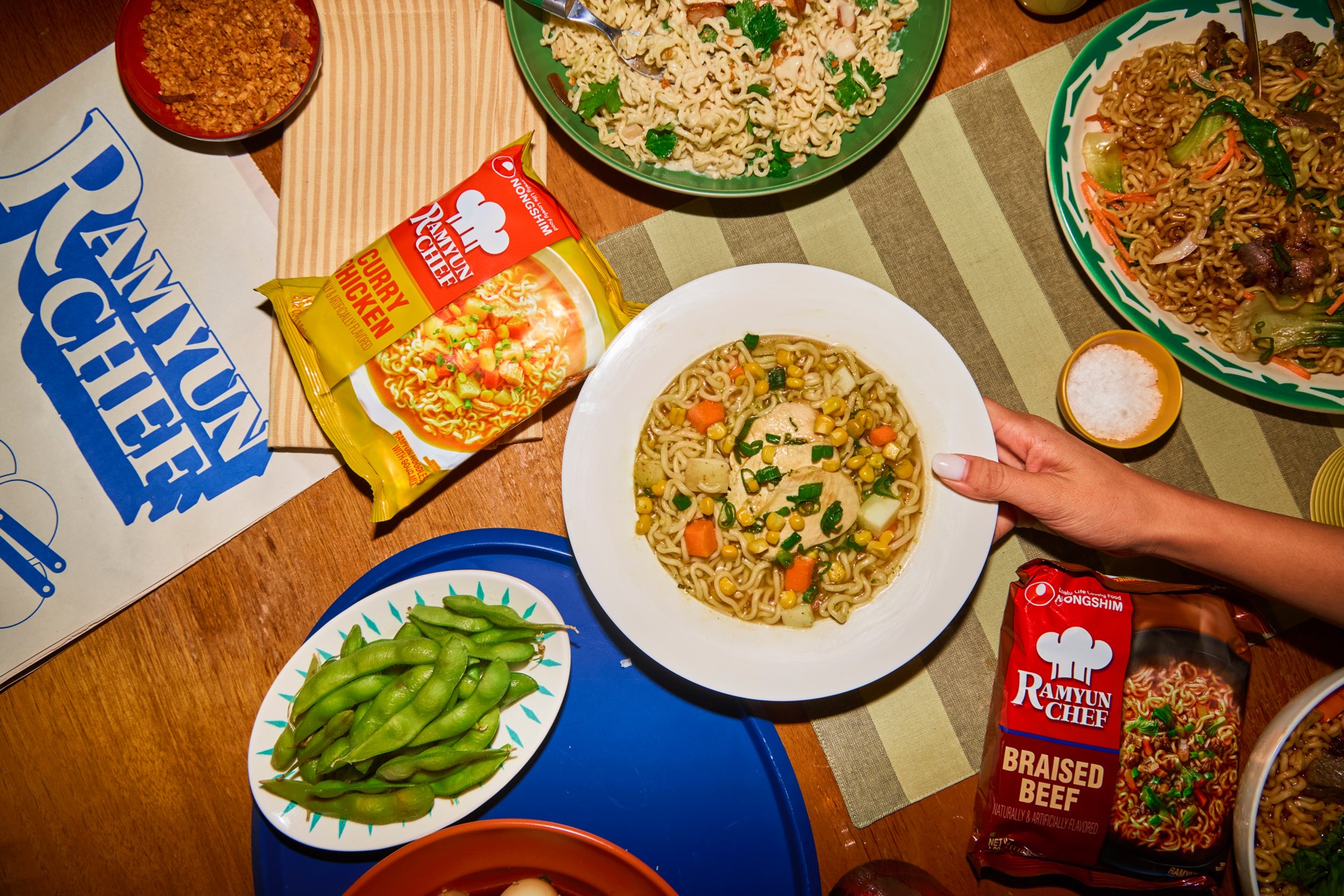Top-down spread of Ramyun Chef dishes with Curry Chicken and Braised Beef packs